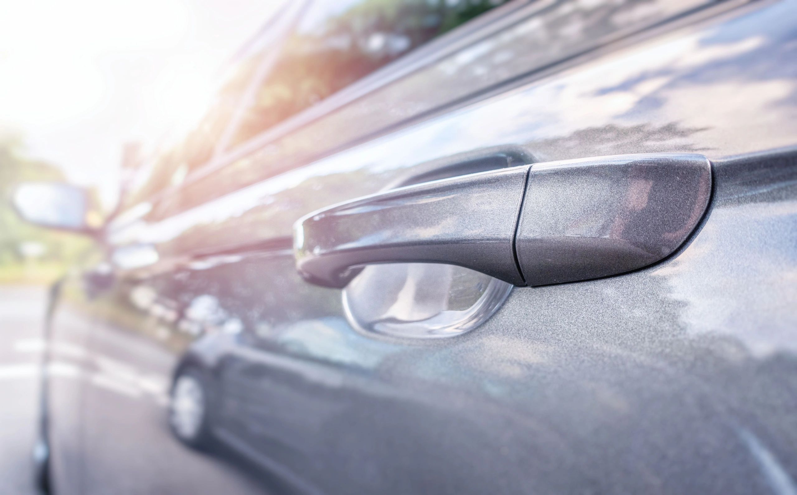 Clean polished car door handle with a reflective finish